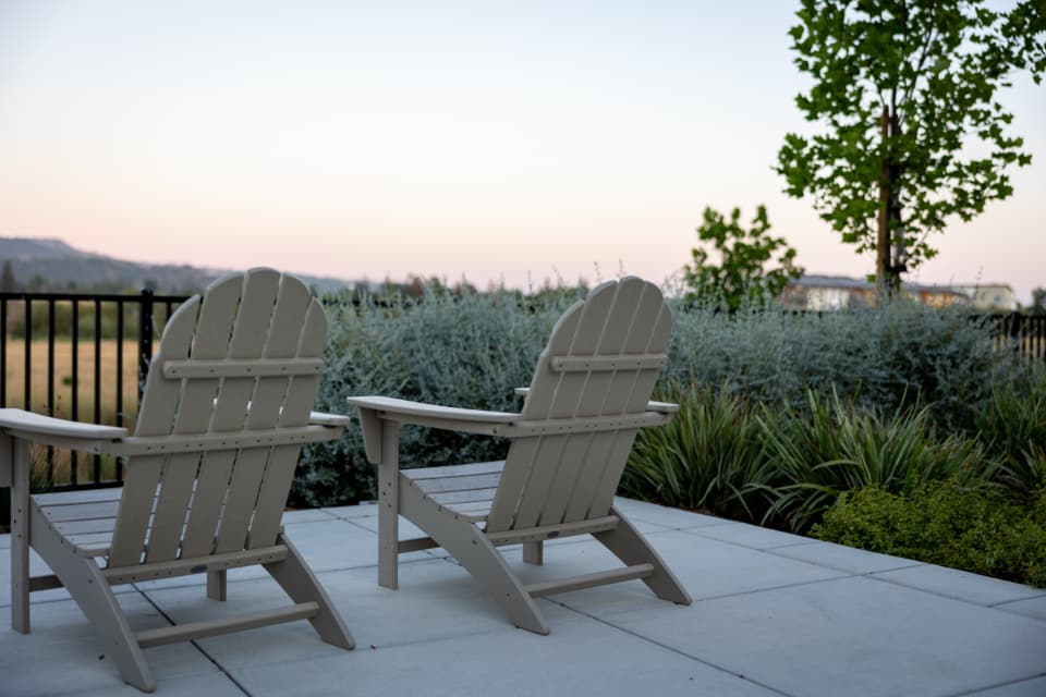 Patio seating framed by clean landscape beds